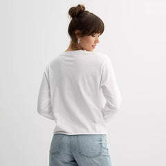 Person wearing a white sweatshirt and blue jeans on a light gray background