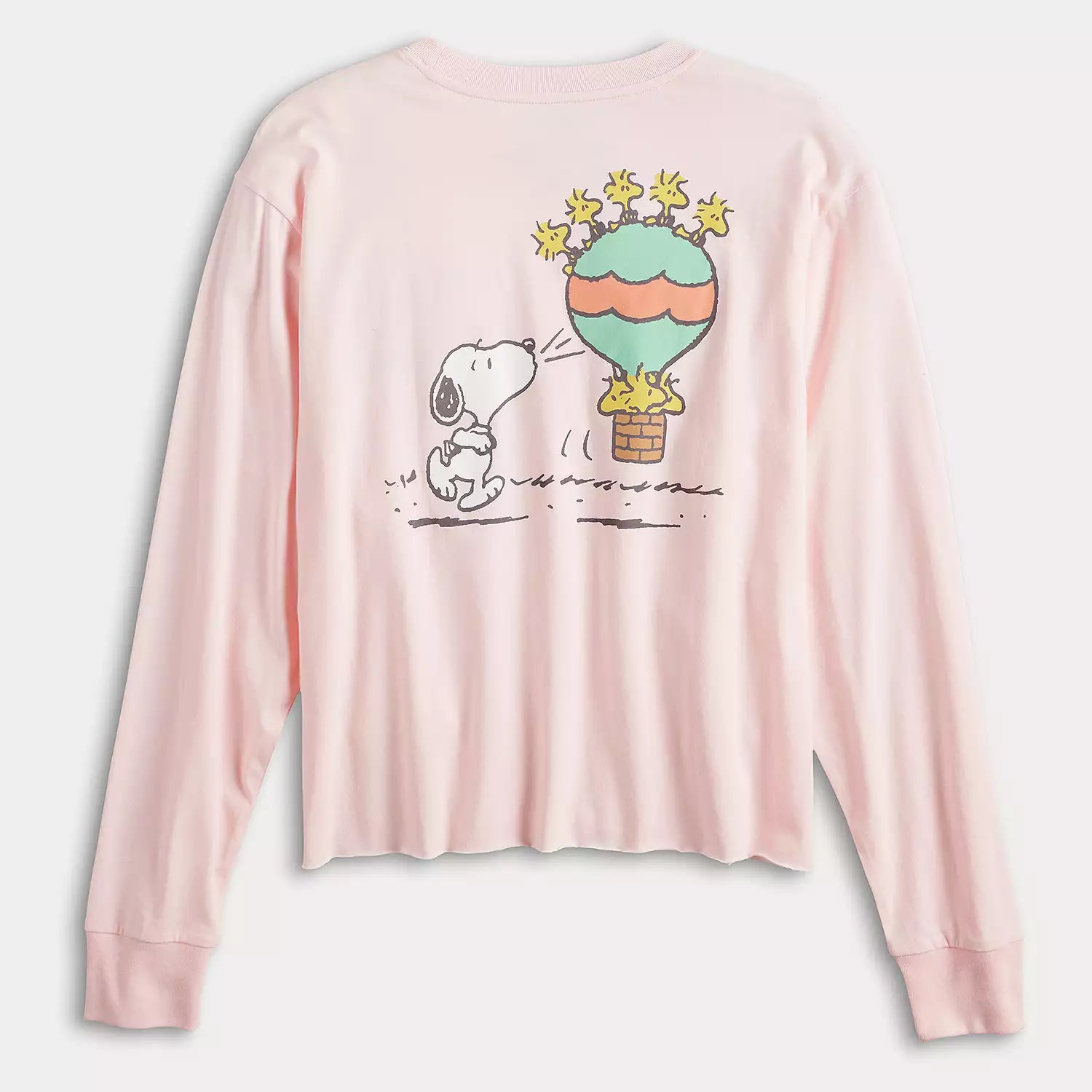 Pink long-sleeve shirt with a cartoon design of a dog and a hot air balloon on a white background