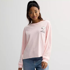 Person wearing a pink sweatshirt with a small logo on a plain background
