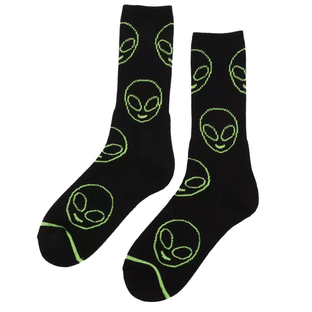 Black socks with green alien face patterns on a white background