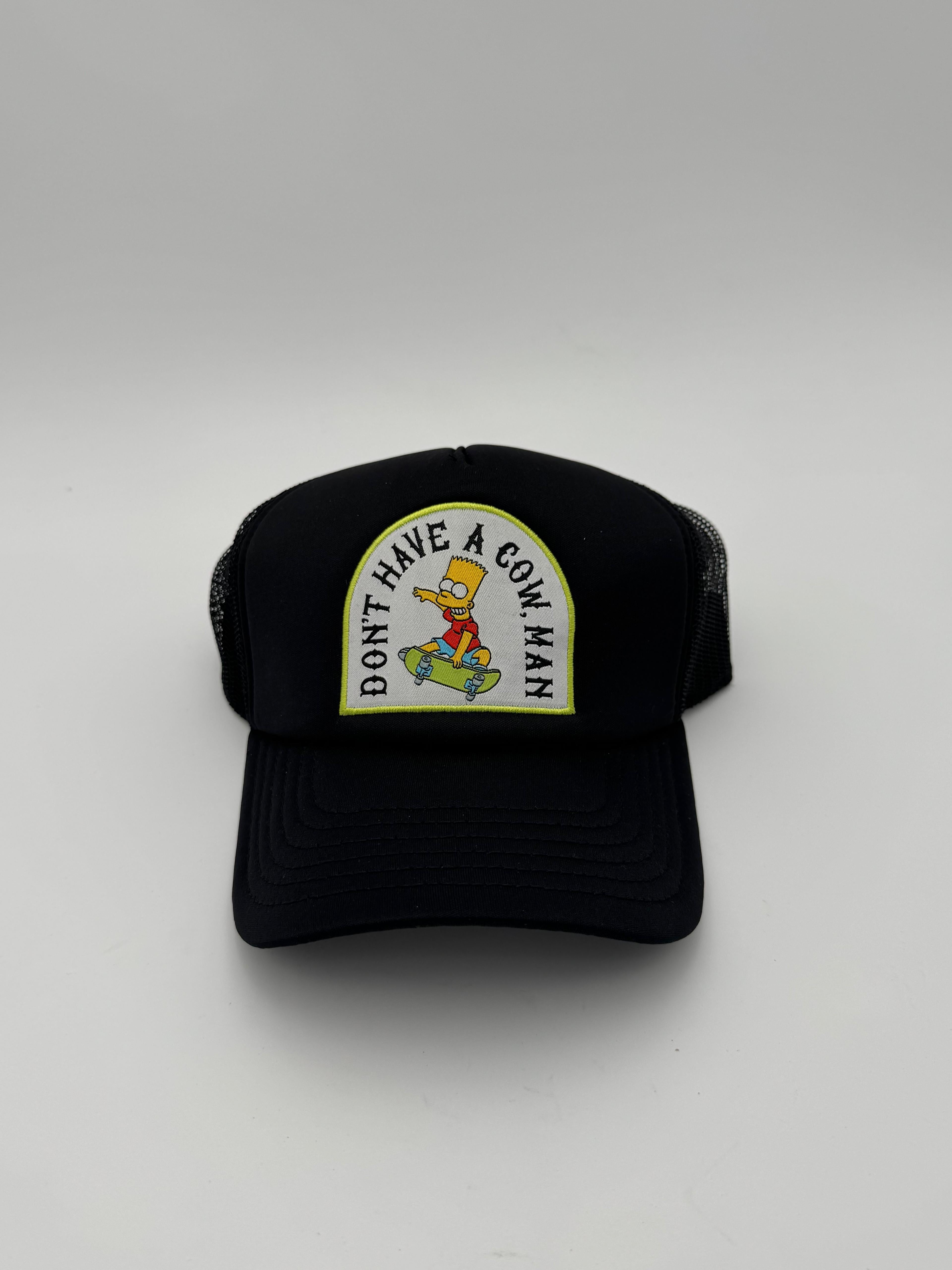 Black cap with a cartoon character patch and text on a white background