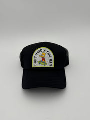 Black cap with a cartoon character patch and text on a white background